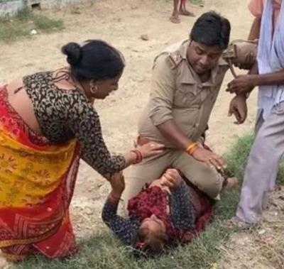 Police official accused of sitting on top of woman, hitting her